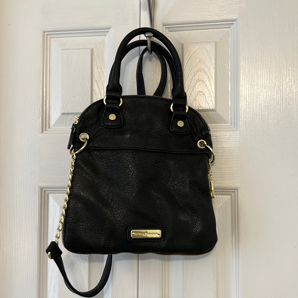 Steve Madden black, faux leather purse with gold hardware and adjustable strap.